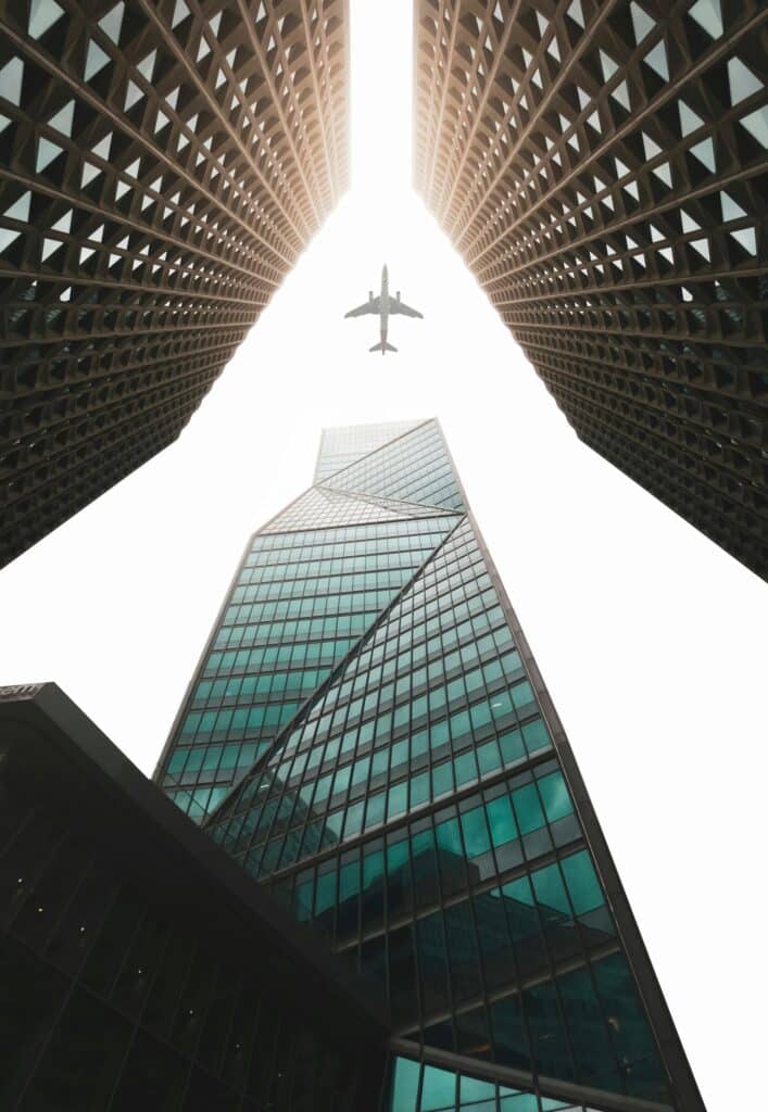 High rise building with plane flying above them