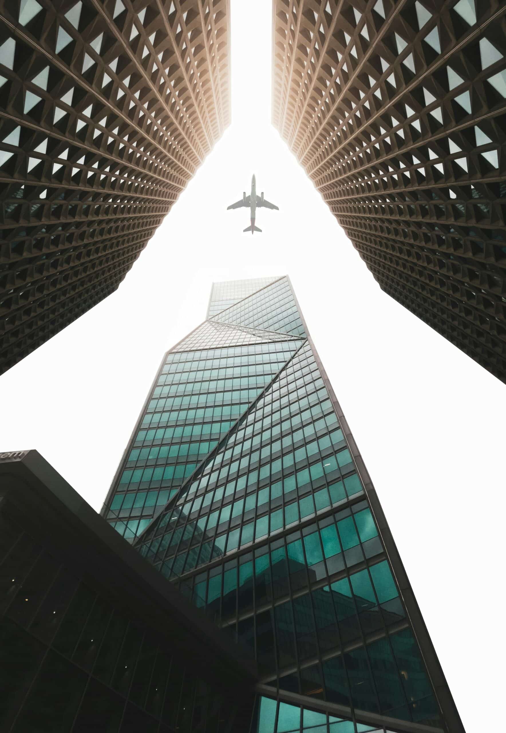 High rise building with plane flying above them