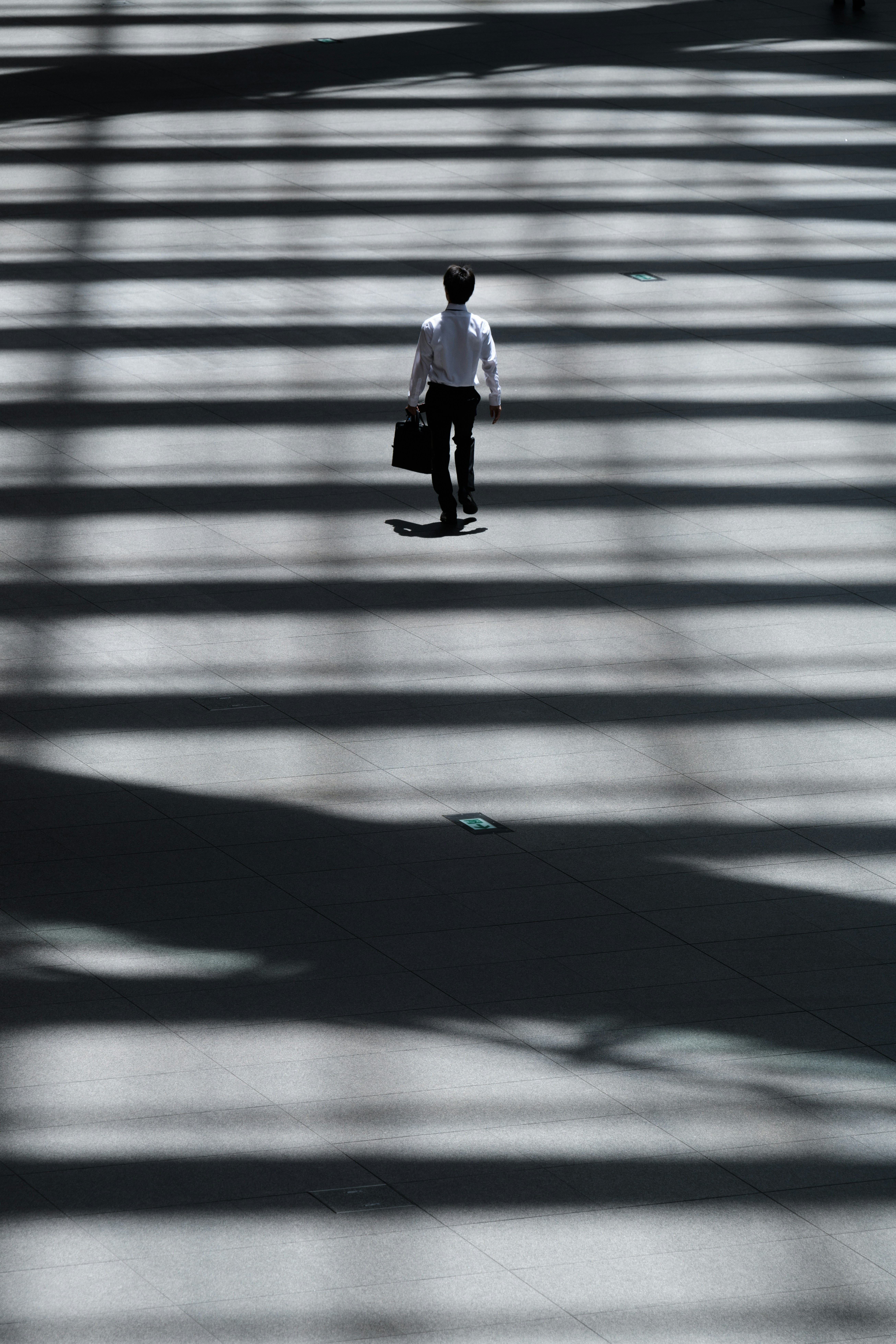 Man walking on zebra crossing Photo by Ryoji Iwata on Unsplash